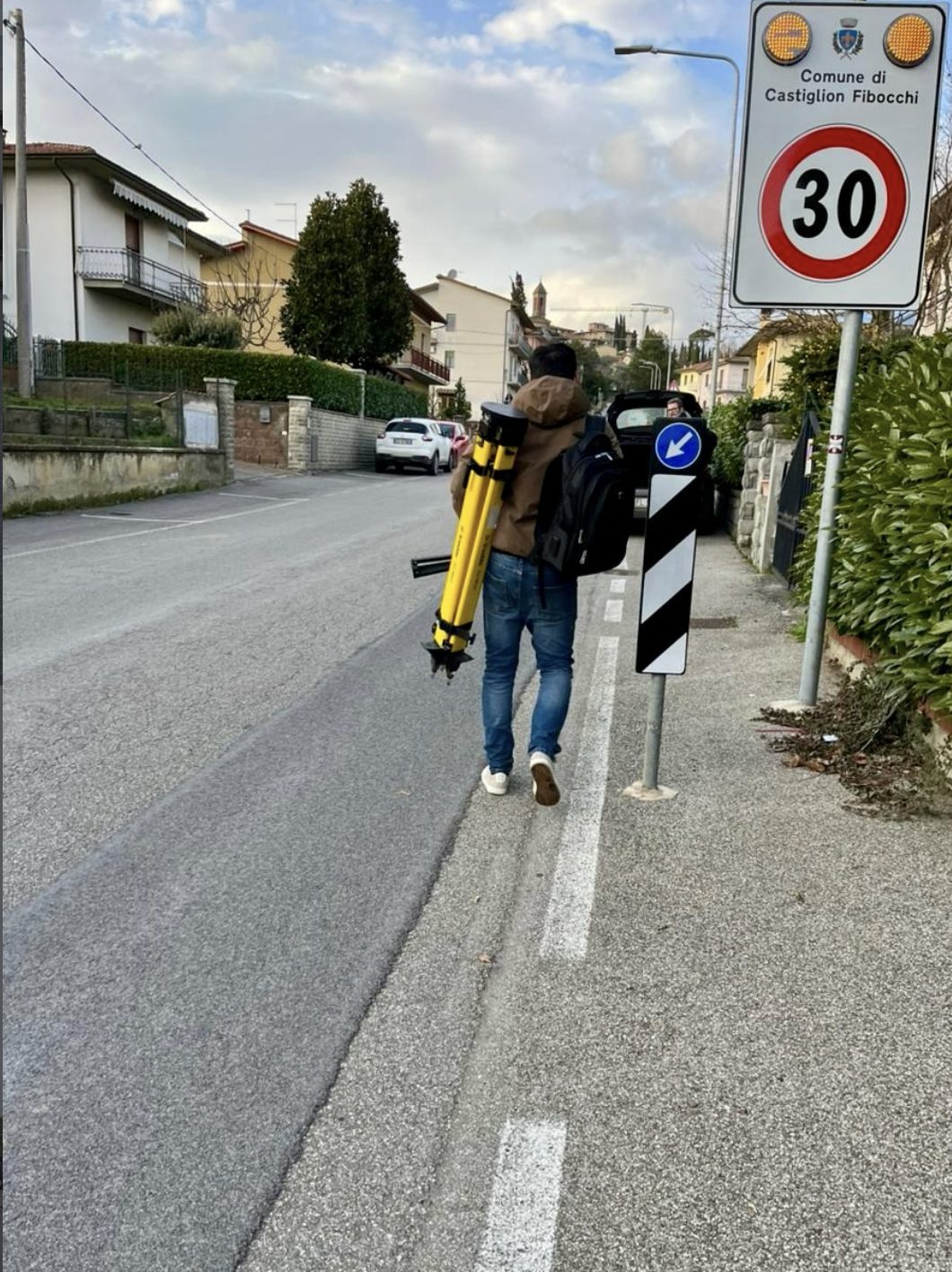 Carrying the survey tripod through Castiglion Fibocchi